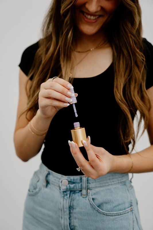 Kami opening a bottle of lilac gel polish